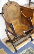 A 17th century style oak bishop's chair, with relief carved lion rampant crest, W.70cm D.58cm