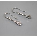 A pair of white metal and graduated diamond set fan-saped drop earrings, overall including ear