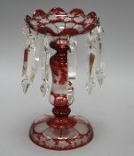 A late 19th century Bohemian ruby overlaid glass table lustre, with spear shaped drops and