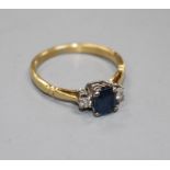 An 18ct, sapphire and diamond three stone ring, size N, gross weight 2.6 grams. Condition: A few