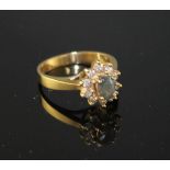 A modern 18k yellow metal, chrysoberyl? and diamond set oval cluster ring, size M, gross weight 4.