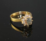 A modern 18k yellow metal, chrysoberyl? and diamond set oval cluster ring, size M, gross weight 4.