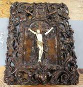 A 19th century European carved walnut and ivory crucifix, the ivory Corpus Christi on a pierced