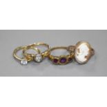 Four assorted 9ct and gem set rings. Condition: 9ct gold and collet set solitaire diamond ring, size