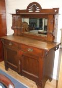 An Edwardian Maple & Co oak chiffonier, with mirrored back, two drawers and two panelled doors, W.