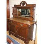 An Edwardian Maple & Co oak chiffonier, with mirrored back, two drawers and two panelled doors, W.