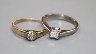 A modern 18ct white gold and princess cut solitaire diamond ring and a 585 and solitaire diamond