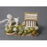 A rare Staffordshire porcelain figure a poodle outside its kennel, c.1835-50, attributed to Lloyd