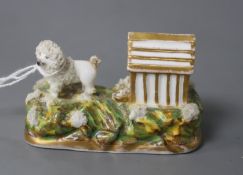 A rare Staffordshire porcelain figure a poodle outside its kennel, c.1835-50, attributed to Lloyd