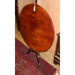 A George III mahogany circular tilt top table on pillar and tripod base, Diameter 84cm, H.71cm