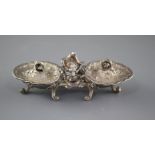 An 18th century French rococco white metal double salt, with hinged covers, on scrolling feet, marks