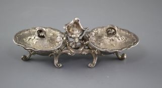 An 18th century French rococco white metal double salt, with hinged covers, on scrolling feet, marks