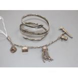 A modern silver and niello serpent bangle and a white metal tassle bracelet hung with four