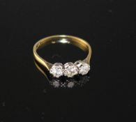 An 18ct and Plat, three stone diamond ring, size P, gross weight 1.8 grams, total diamond weight