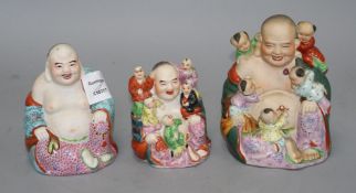 Three Chinese famille rose groups of Budai, mid 20th century, two modelled with children and with