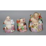 Three Chinese famille rose groups of Budai, mid 20th century, two modelled with children and with