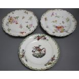 A Chelsea gold anchor 'bird and insect' plate and a similar pair of floral plates, c. 1765, 22 and