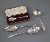 Two 18th century silver 'berry spoons' a George III silver sauce ladle, London, 1773 and a cased