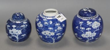 Three Chinese blue and white 'prunus' jars and two covers, early 20th century, height 12cm - 13.