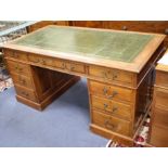 An Edwardian walnut pedestal desk, with later green skiver and nine drawers, W.152cm D.84cm H.76cm