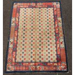 A small Chinese Suiyvan carpet, the fawn ground field woven with a lattice pattern, each cross