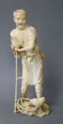 A Japanese ivory Tokyo School ivory okimono, carved as a farmer above a chicken, Meiji period,