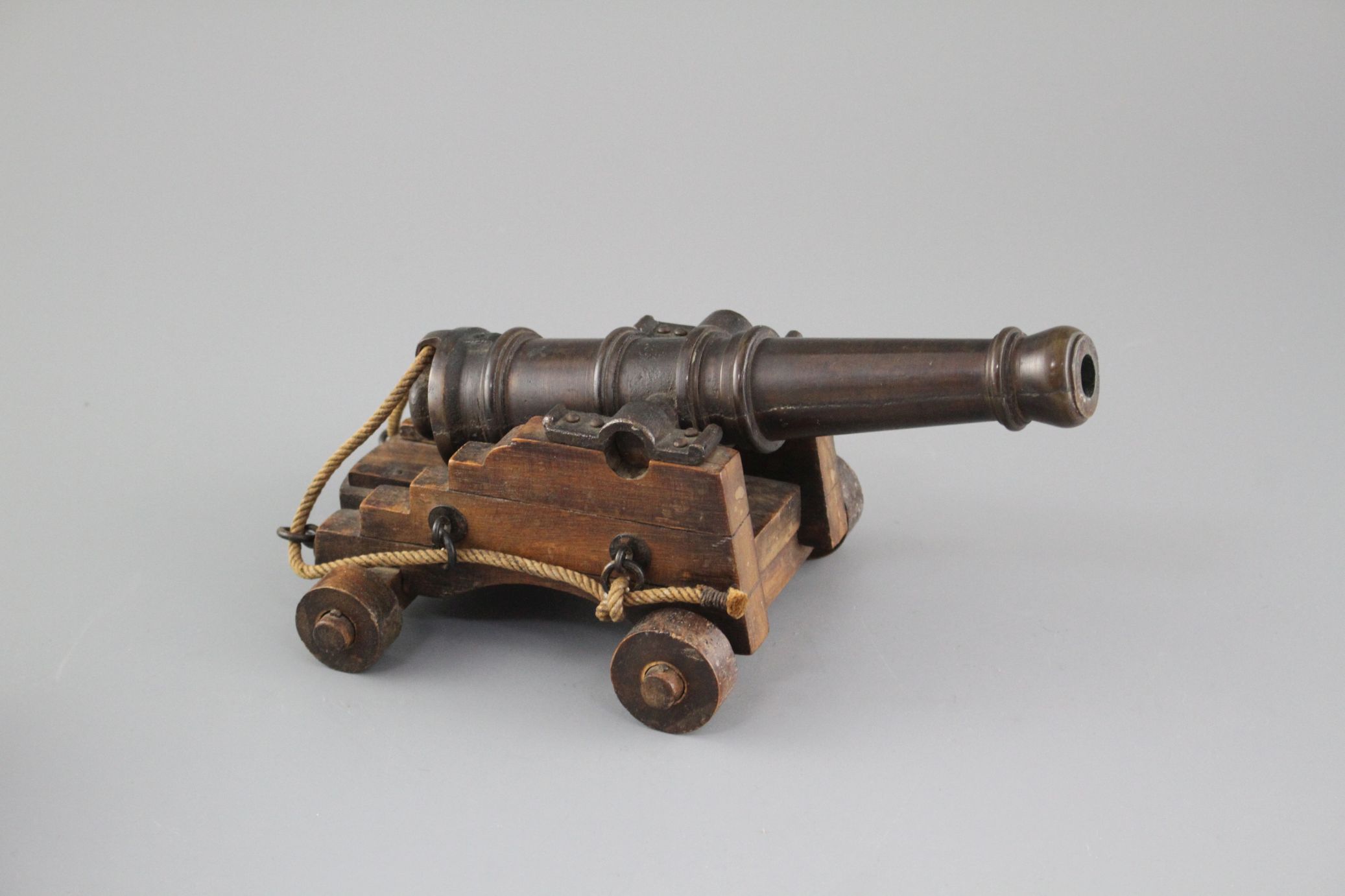 An early 20th century bronze model of a Naval cannon, on wooden trunnion base, length 25cm - Image 3 of 6