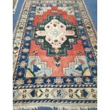 A Caucasian Kazak geometric rug, 295 x 175cm Condition: Possibly a little faded with patches of wear