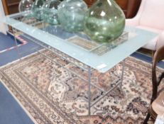 A contemporary wrought iron and glass top rectangular table, L.214cm H.79cm Condition: Glass top