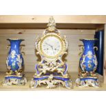 A 19th century French Ed Honore of Paris porcelain three piece clock garniture, clock 34cm, vases