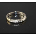 A modern 18ct white gold and ten stone diamond chip set half eternity ring, size M, gross weight 4.5
