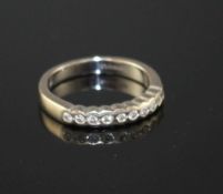 A modern 18ct white gold and ten stone diamond chip set half eternity ring, size M, gross weight 4.5