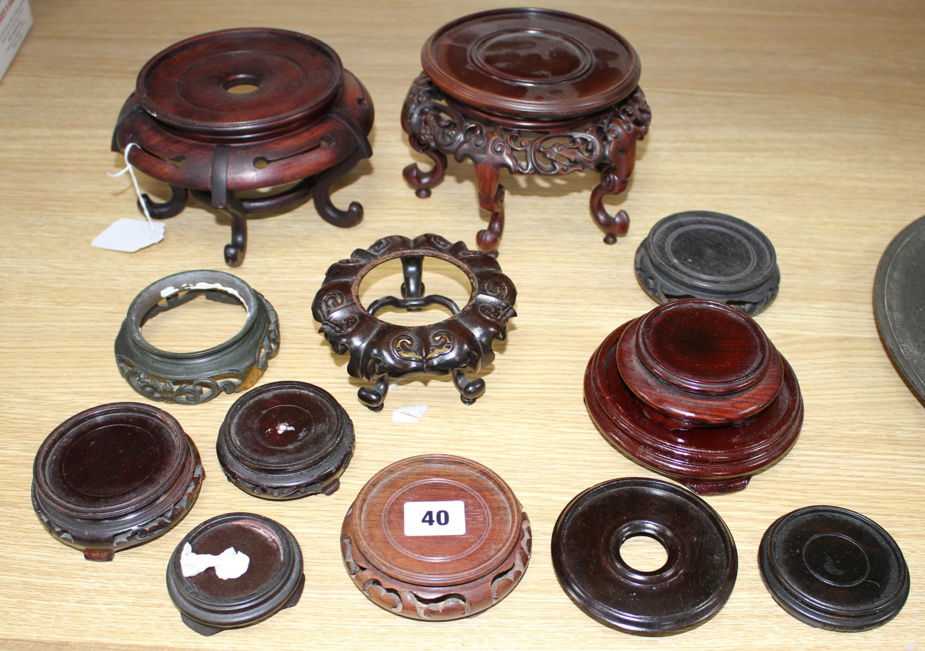 Thirteen assorted mainly Chinese hardwood vase stands, largest diameter 17cm, height 12cm