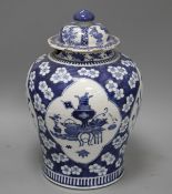 A 19th century Chinese blue and white jar, with panelled decoration, height 28cm and an associated