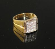 An 18k yellow metal and nine stone pave set diamond square signet ring, size W/X, gross 14.5
