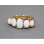 An Edwardian 18ct gold and graduated five stone white opal half hoop ring, size Q, gross 5.5