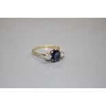 An 18ct and Plat, sapphire and diamond set three stone ring, size O/P, gross weight 2.3 grams.