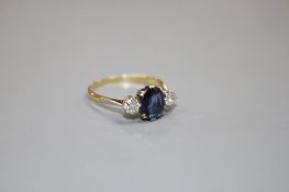 An 18ct and Plat, sapphire and diamond set three stone ring, size O/P, gross weight 2.3 grams.