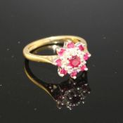 A modern 18ct gold, ruby and diamond set flower head cluster ring, size I, gross weight 3.7 grams.