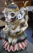 A large painted Balinese wooden kris stand modelled as a seated Ganesh, 20th century, height 51cm