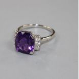 A white metal, amethyst and six stone diamond set dress ring, size R/S, gross weight 6.2 grams.