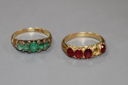 A George V yellow metal, graduated five stone emerald and diamond chip ring and one other four(ex
