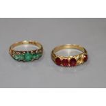 A George V yellow metal, graduated five stone emerald and diamond chip ring and one other four(ex