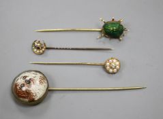 A yellow metal and scarab set stick, three others including Essex crystal style, pearl and pear