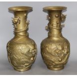A pair of Chinese gilt bronze vases, decorated with dragons in relief, height 41cm Condition: