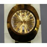 A gentleman's gilt stainless steel Rado Diastar automatic day/date wrist watch, with blue stone