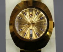 A gentleman's gilt stainless steel Rado Diastar automatic day/date wrist watch, with blue stone