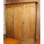 A late Victorian pine breakfront wardrobe, W.200cm D.74cm H.206cm Condition: Some minor dents and