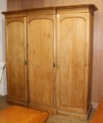 A late Victorian pine breakfront wardrobe, W.200cm D.74cm H.206cm Condition: Some minor dents and