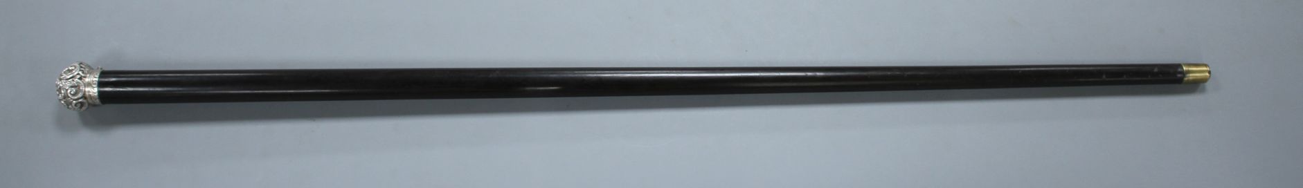 A Victorian walking stick with embossed silver pommel H.M., Birmingham 1906, opens to reveal a